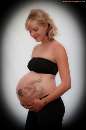 Pregnant woman with a superimposed image of a grown man in the fetal position on her belly.