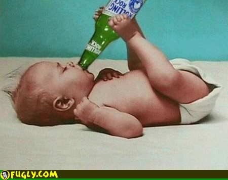 A diapered baby lies on a pale bed, drinking from a green bottle against a teal background, echoing a breastfeeding vs formula feeding debate.