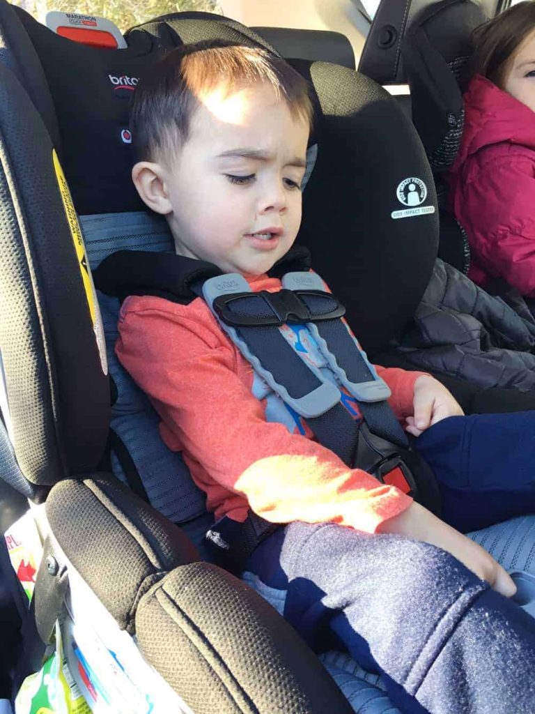 Young boy buckled into a black Britax Marathon ClickTight convertible car seat in the back of a vehicle.