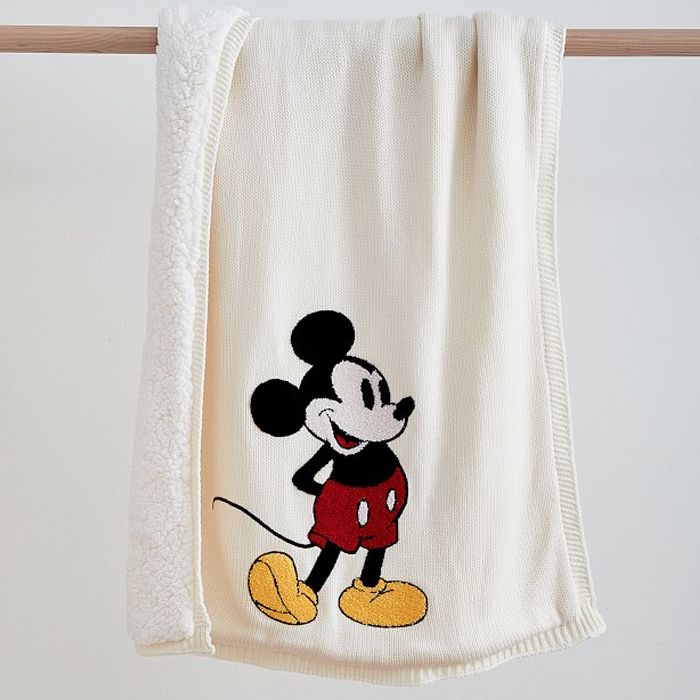White knit baby blanket with a classic Mickey Mouse illustration and a white sherpa fleece lining.