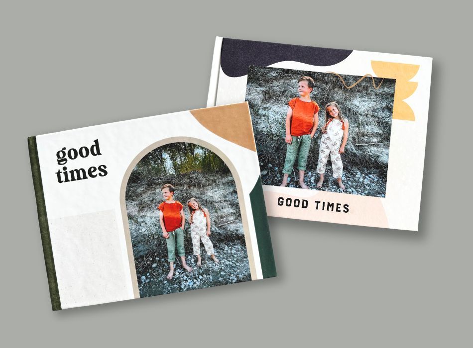 Two custom photo books titled Good Times featuring the same photo of two children outdoors on different cover designs.