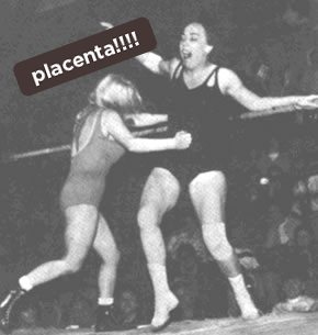 Black and white photo of a female wrestler punching another in the stomach, with a placenta label above them.