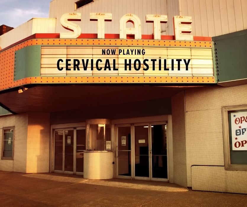 State theater marquee with Now Playing Cervical Hostility in block letters above a ticket booth and entrance doors.