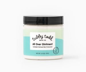 Tubby Todd All Over Ointment with colloidal oatmeal in a 3.5 oz clear jar with a black lid and blue label.