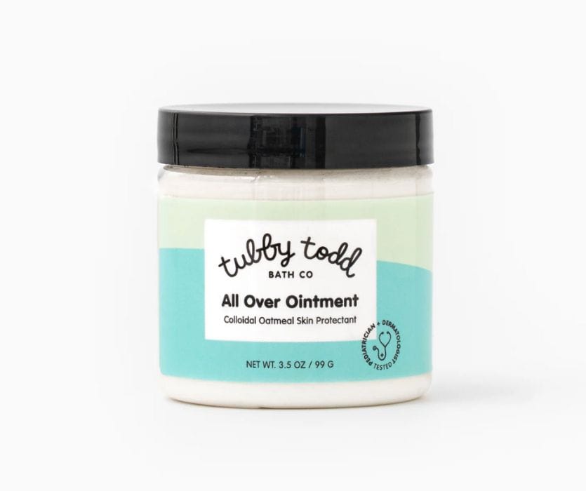 Tubby Todd All Over Ointment with colloidal oatmeal in a 3.5 oz clear jar with a black lid and blue label.