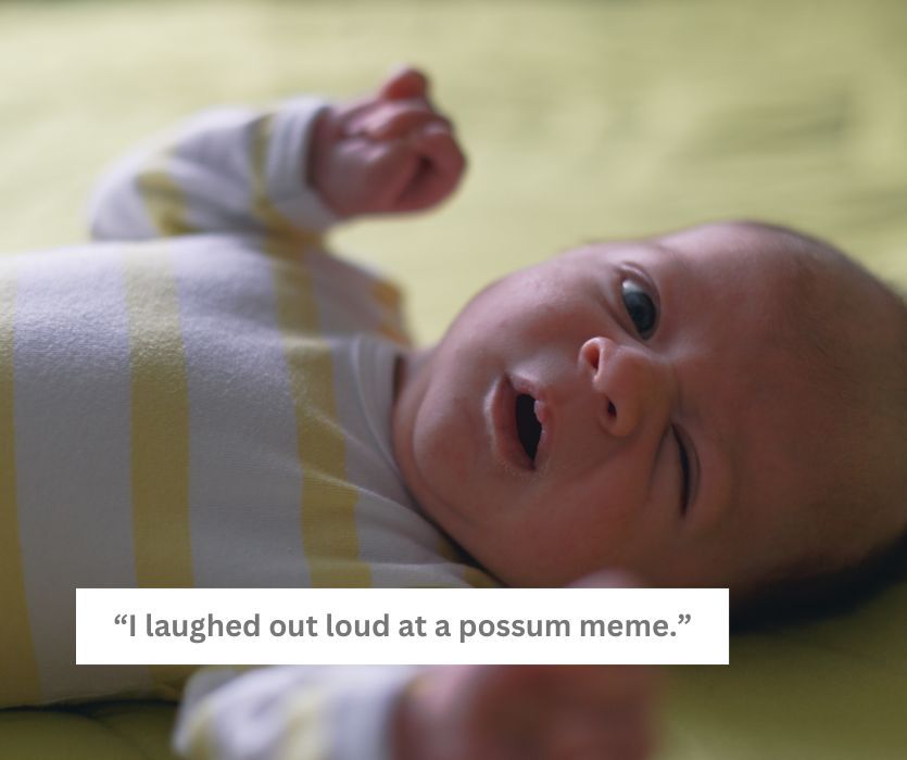 A newborn baby in a striped onesie waking up with a squint and open mouth. Text: I laughed out loud at a possum meme.
